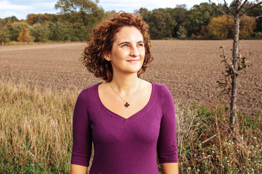 Herbst Pullover nähen mit Schnittmuster - hier mein fertiges Teil in Brombeer-Farbe vor einem herbstlichen Feld